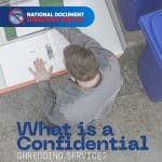 Person checking confidential documents before placing them in a shredding bin for secure disposal.